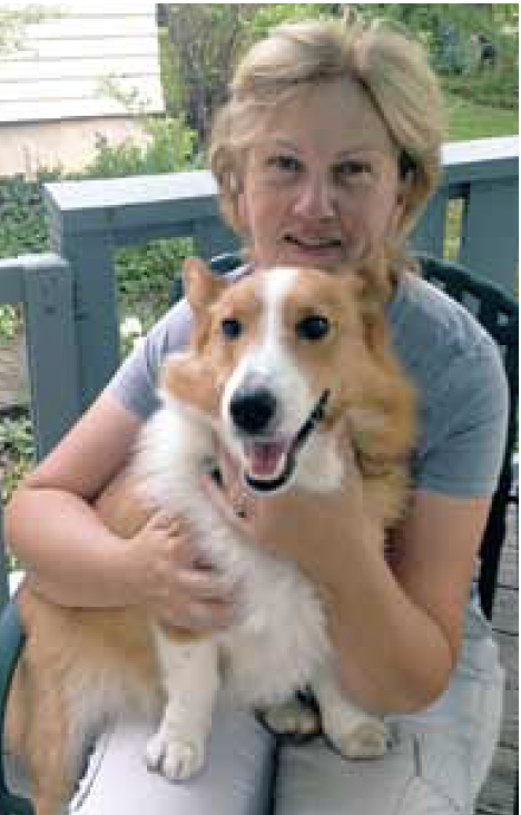 Woman holding a pet therapy corgi dog
